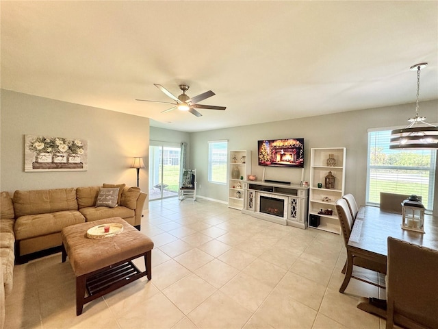 tiled living room featuring a wealth of natural light and ceiling fan