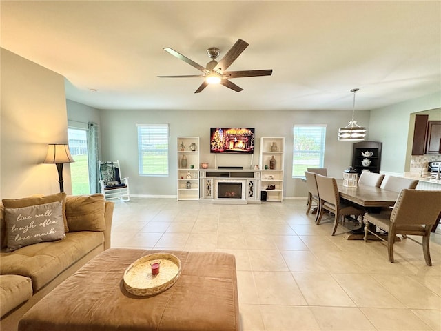 tiled living room featuring ceiling fan and a healthy amount of sunlight