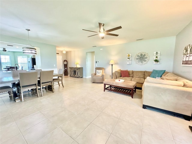 tiled living room with ceiling fan