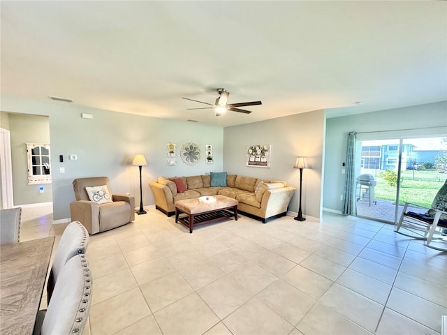 living room featuring ceiling fan and light tile patterned flooring