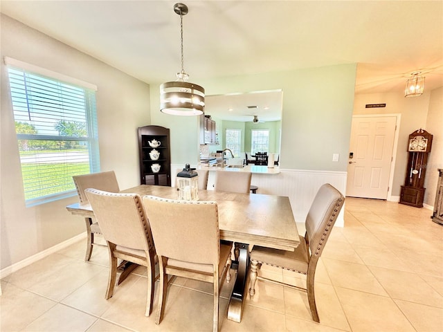 dining room featuring light tile patterned floors, sink, and an inviting chandelier