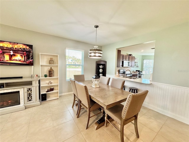 tiled dining space with a chandelier