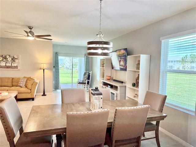 dining space with ceiling fan and light tile patterned floors