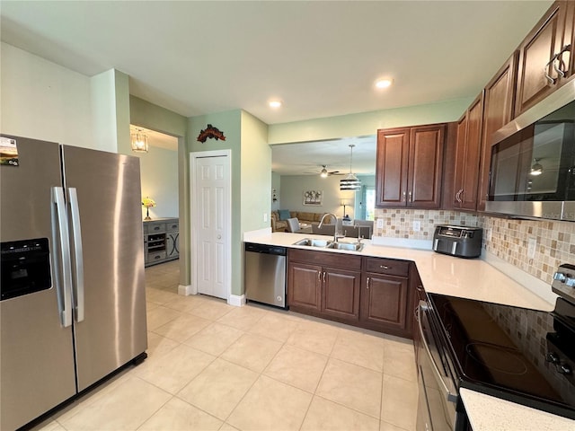 kitchen with decorative backsplash, appliances with stainless steel finishes, ceiling fan, sink, and light tile patterned flooring