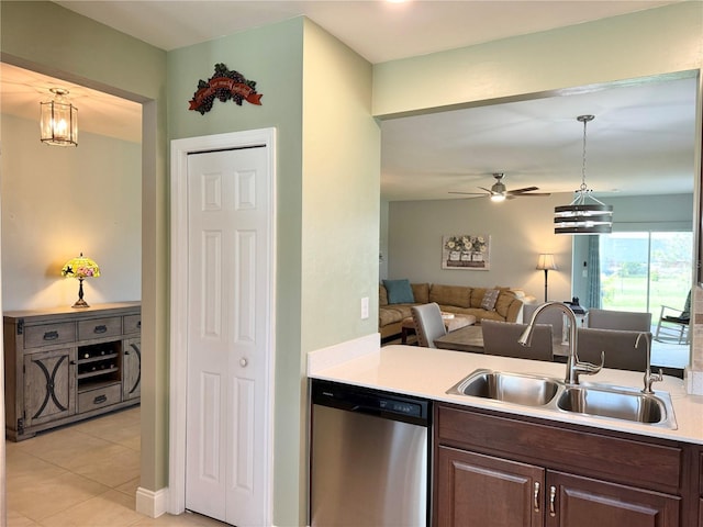 kitchen featuring stainless steel dishwasher, dark brown cabinetry, ceiling fan with notable chandelier, sink, and hanging light fixtures