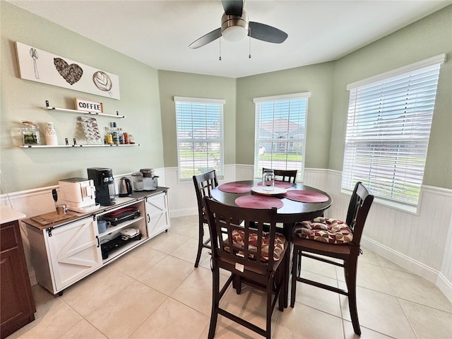 tiled dining area with ceiling fan