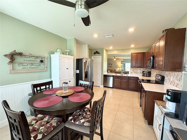 dining area featuring ceiling fan, light tile patterned flooring, and sink