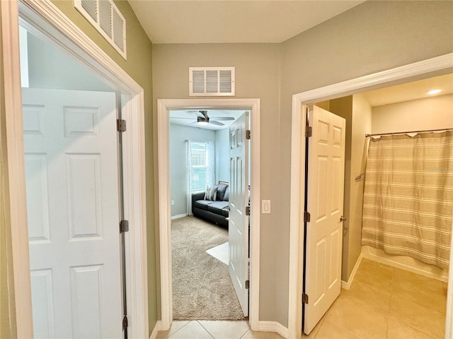 hallway with light colored carpet