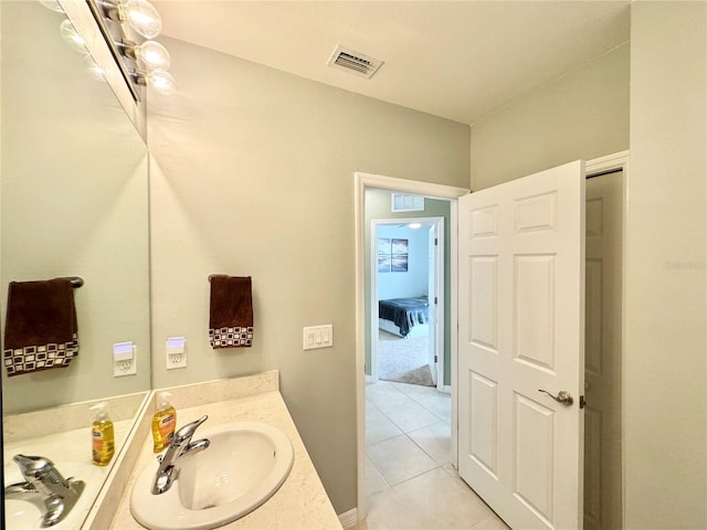 bathroom featuring tile patterned flooring and vanity