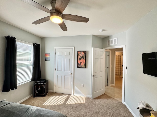 unfurnished bedroom featuring ceiling fan and light colored carpet