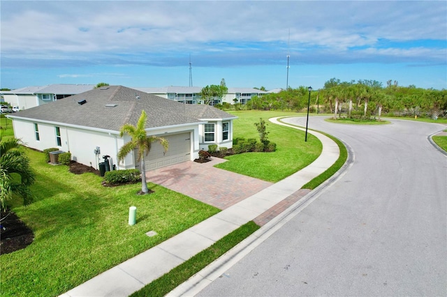 view of front of house featuring a garage and a front lawn