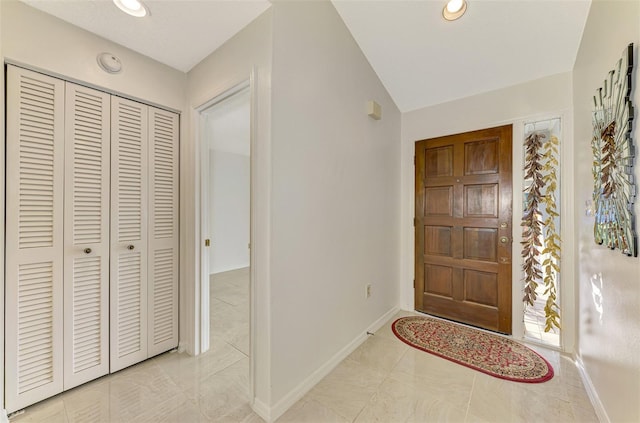 foyer entrance featuring vaulted ceiling