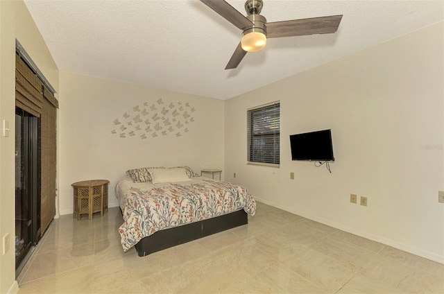 bedroom with a textured ceiling and ceiling fan