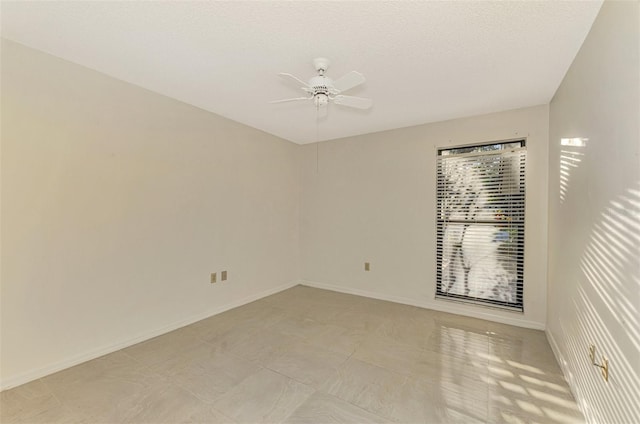 spare room with ceiling fan and a textured ceiling