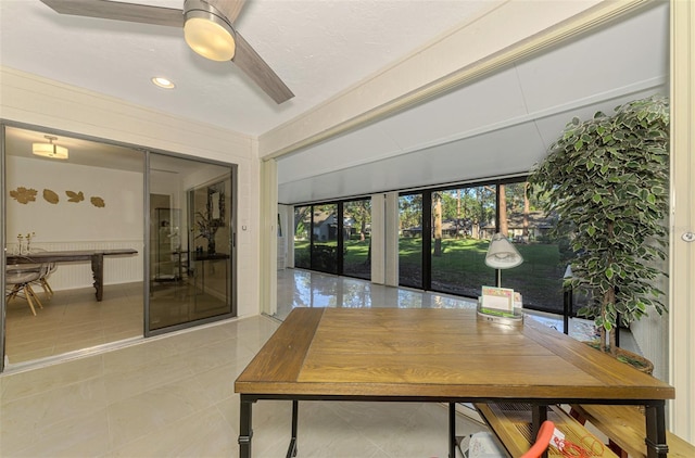 tiled home office with ceiling fan and french doors