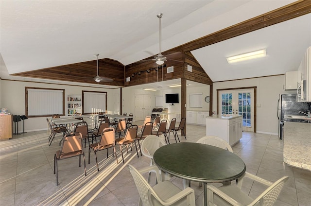 dining space featuring ceiling fan, lofted ceiling, light tile patterned floors, and french doors