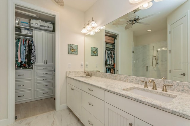 bathroom featuring an enclosed shower, ceiling fan, and vanity