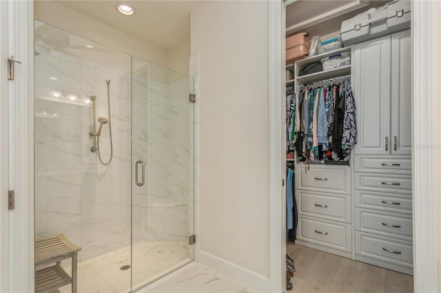 bathroom featuring a shower with shower door