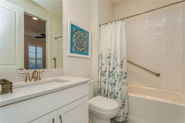 full bathroom featuring toilet, vanity, ceiling fan, and shower / bathtub combination with curtain