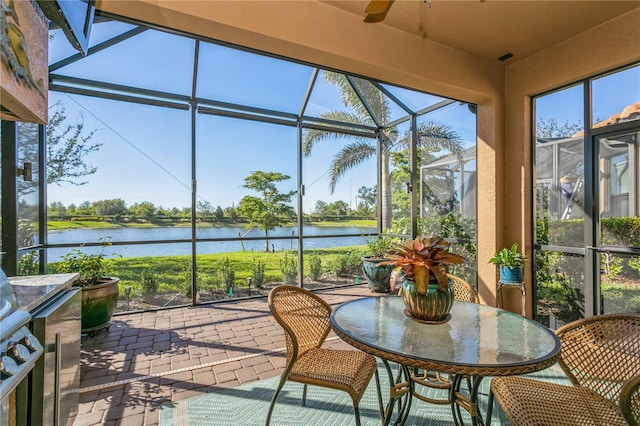 sunroom featuring a healthy amount of sunlight and a water view