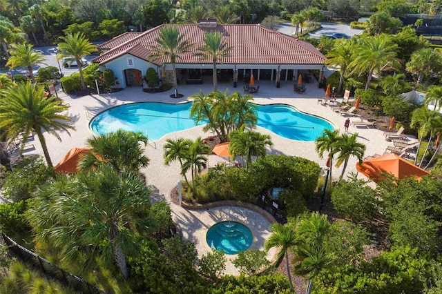 view of swimming pool featuring a patio area and a hot tub