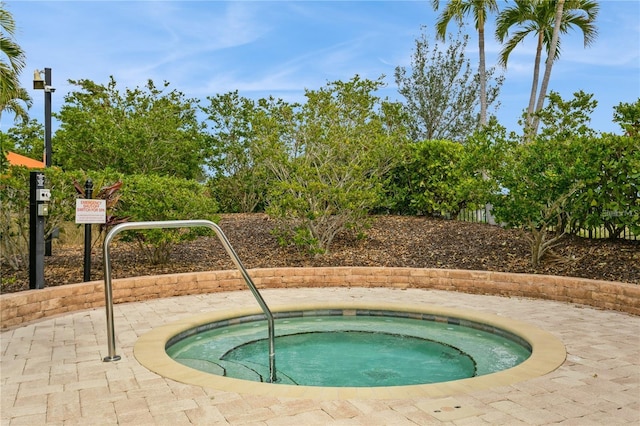 view of swimming pool with a community hot tub