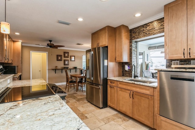 kitchen with sink, crown molding, ceiling fan, decorative light fixtures, and stainless steel appliances