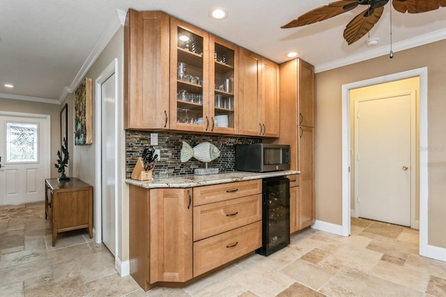 bar with ceiling fan, ornamental molding, tasteful backsplash, light stone counters, and beverage cooler