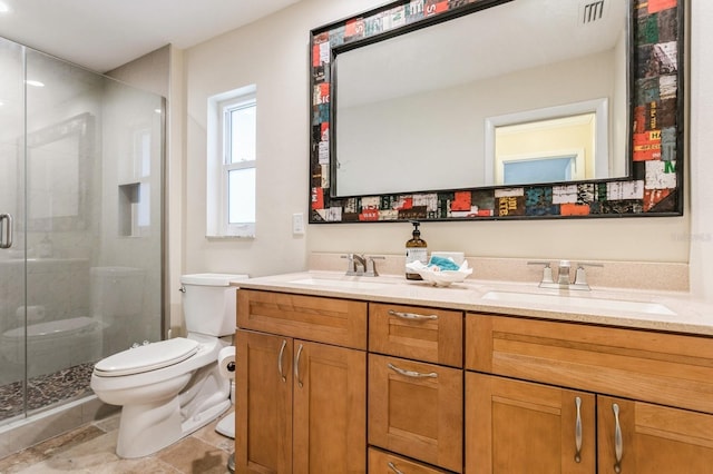 bathroom with vanity, a shower with shower door, and toilet