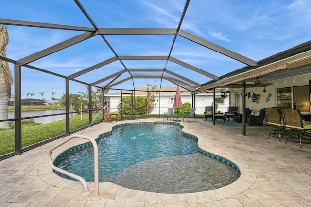 view of pool featuring a patio, a water view, ceiling fan, and a lanai