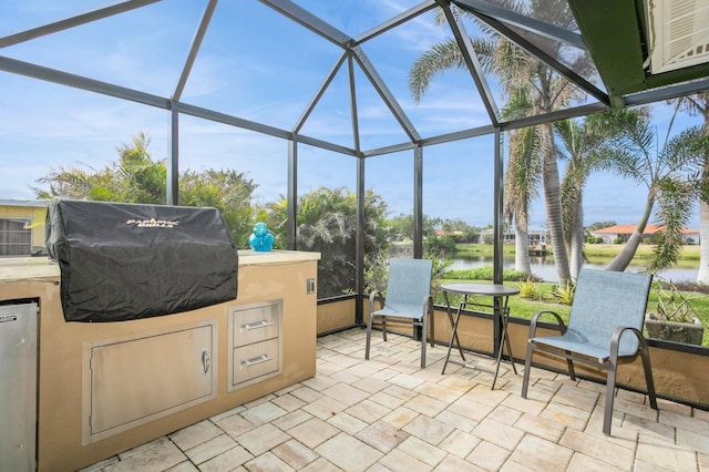 view of patio with a water view, area for grilling, grilling area, and a lanai