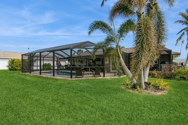 view of yard featuring glass enclosure and a patio area