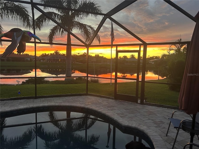 exterior space featuring a lanai, a water slide, a water view, and a patio