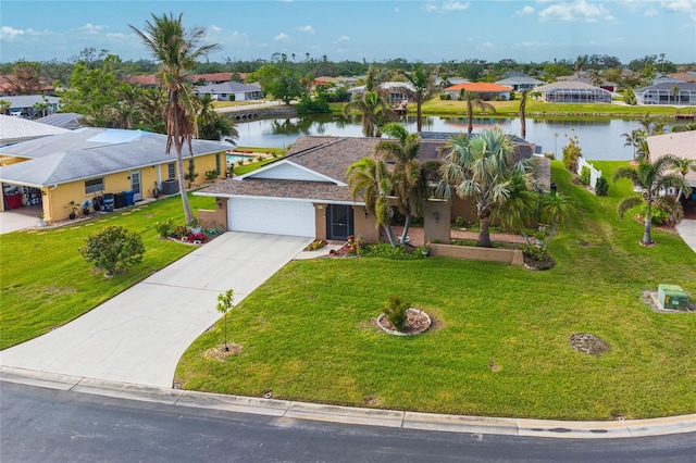 view of front of property with a front yard, central AC, a water view, and a garage