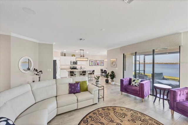 living room featuring a water view, light hardwood / wood-style flooring, and ornamental molding