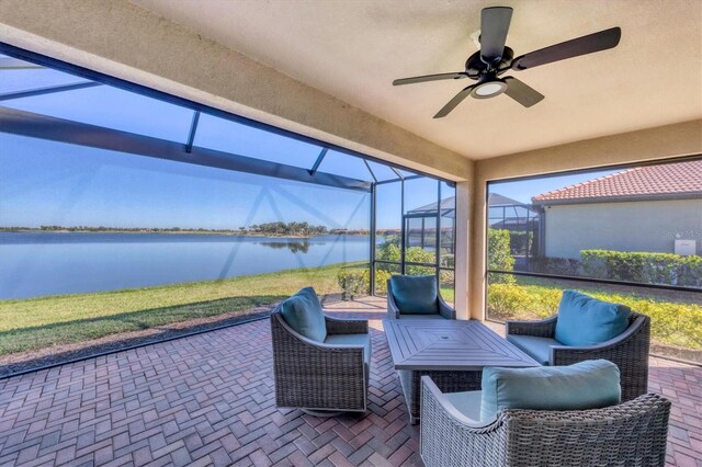 sunroom / solarium featuring ceiling fan and a water view