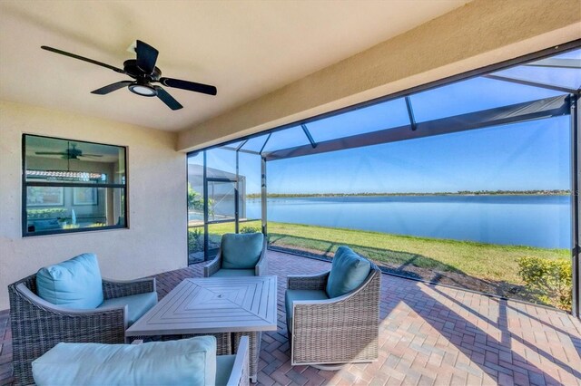 view of patio / terrace featuring a lanai, ceiling fan, and a water view