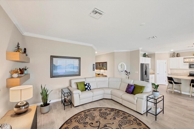 living room featuring light hardwood / wood-style floors and ornamental molding