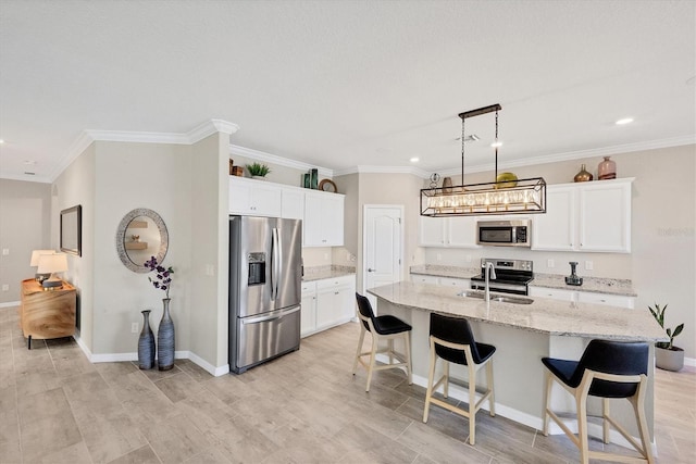 kitchen with stainless steel appliances, white cabinetry, a kitchen island with sink, and sink