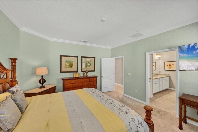 bedroom featuring light colored carpet, ornamental molding, a textured ceiling, and connected bathroom