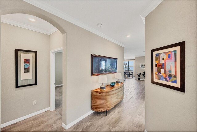 hall featuring crown molding and light hardwood / wood-style flooring