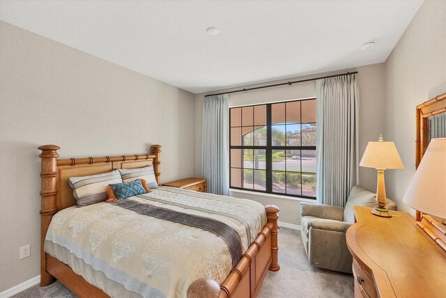 bedroom featuring light carpet