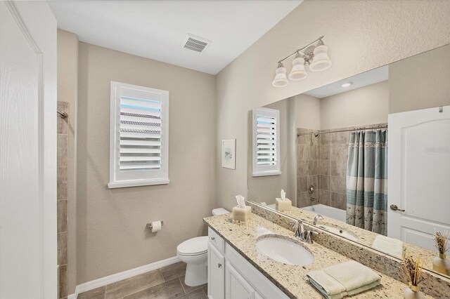 full bathroom with toilet, plenty of natural light, vanity, and shower / tub combo with curtain