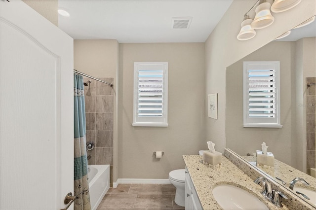 full bathroom featuring tile patterned flooring, vanity, toilet, and shower / bath combo with shower curtain