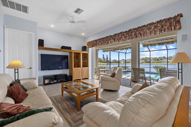 living room with ceiling fan and light tile patterned floors