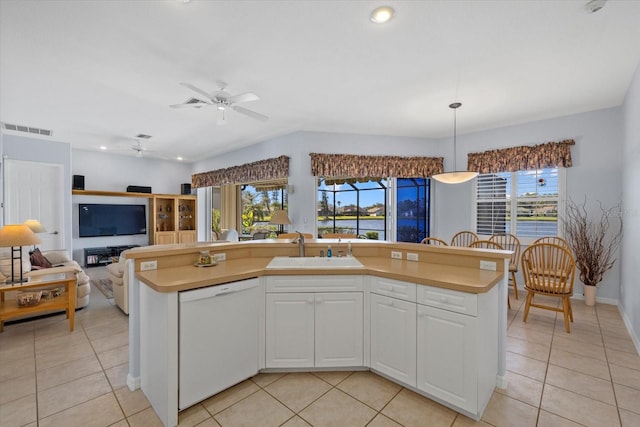 kitchen with white dishwasher, white cabinetry, plenty of natural light, and sink