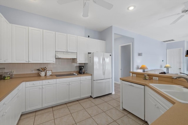 kitchen featuring white appliances, backsplash, white cabinets, sink, and light tile patterned flooring