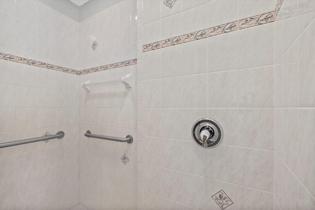 bathroom with a tile shower