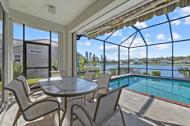 view of pool featuring a lanai, a patio area, and a water view