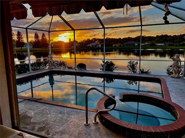 pool at dusk with a lanai and a water view